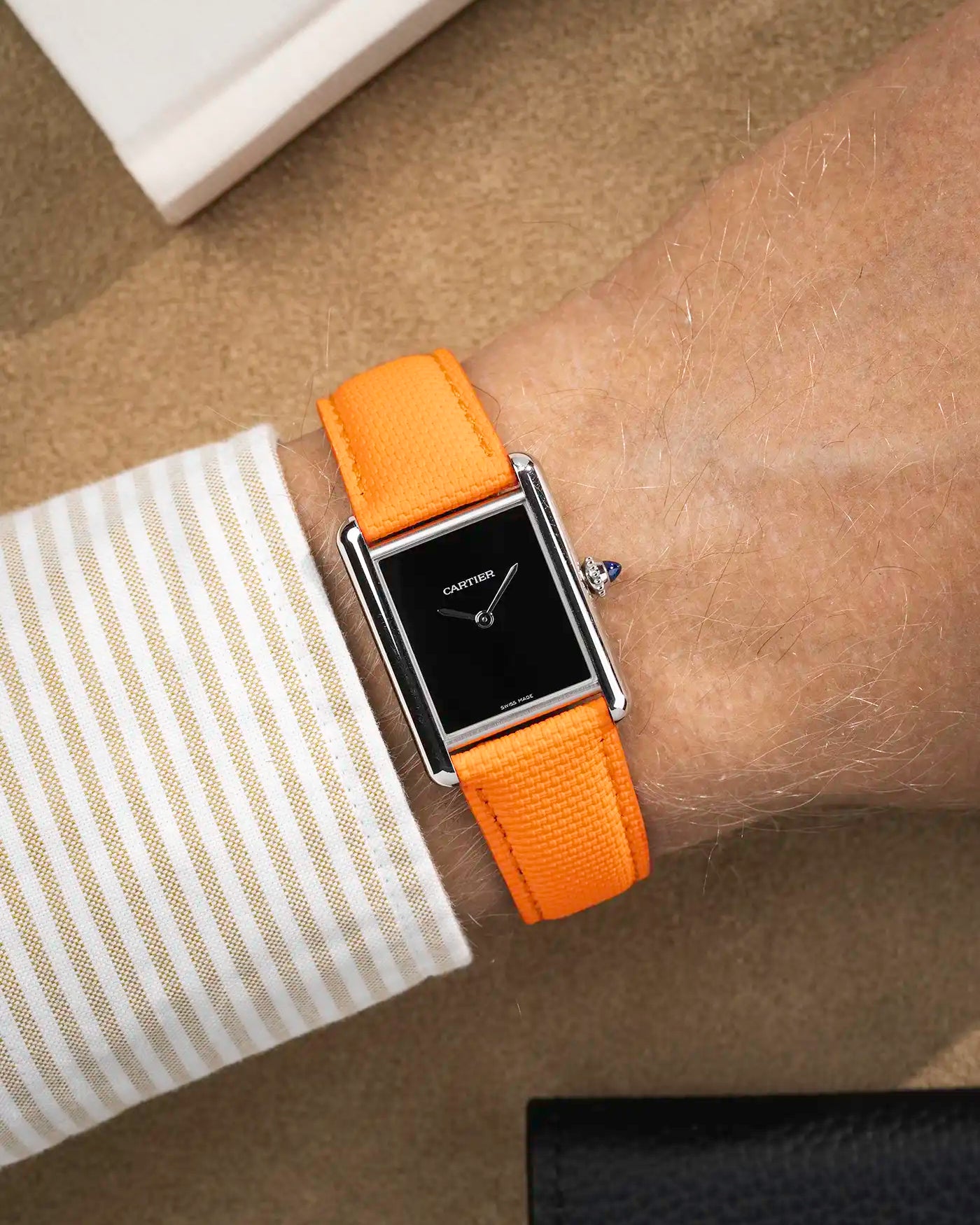 orange rubberised sailcloth leather strap shown on wrist – black dial version for collection view