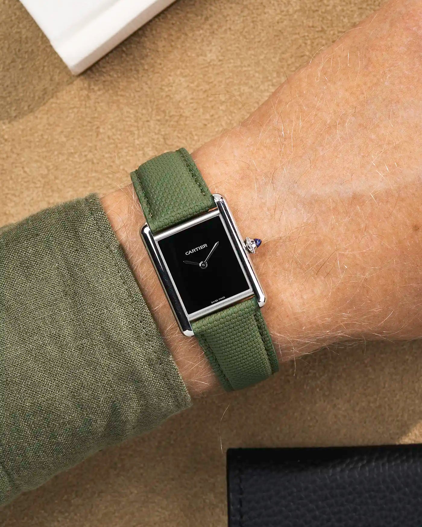 Rubberised sailcloth leather watch strap on Cartier Tank Must with black dial – dressed wrist shot with soft texture