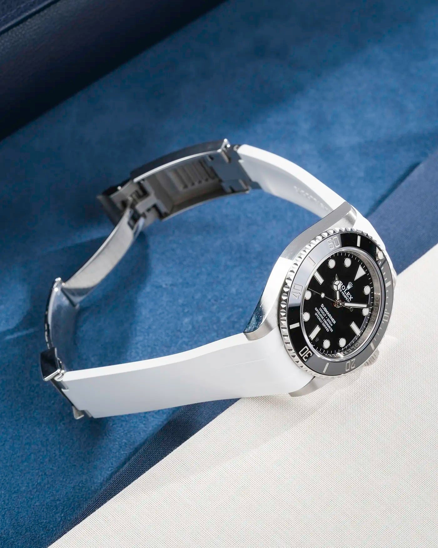 Rolex Submariner 41 with white Classic Smooth FKM Rubber Strap sitting on the watch, integrated with original clasp – product photo side angle with clasp open