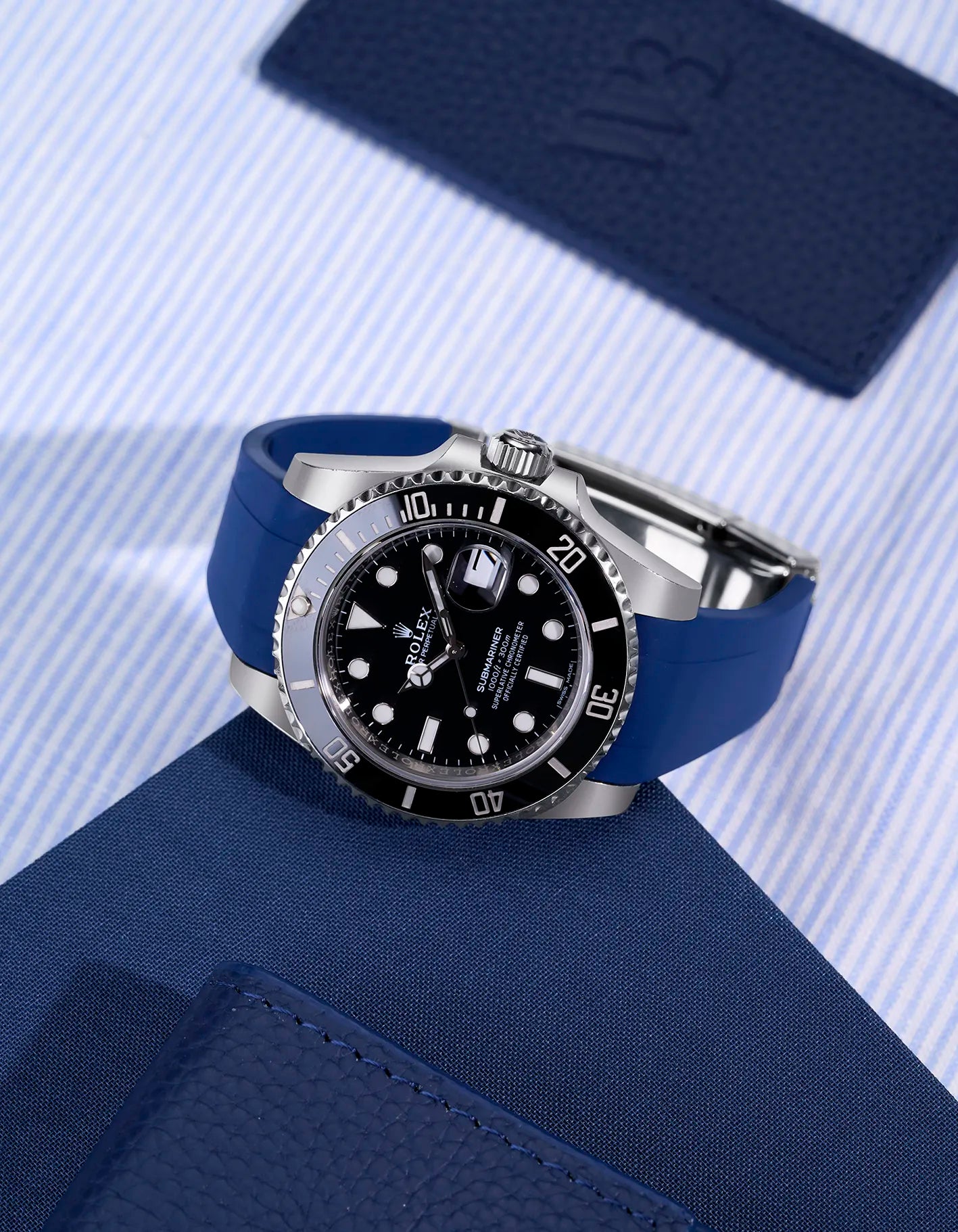 Rolex Submariner 116610LN with blue FKM rubber strap integrated with original Rolex clasp on flatlay
