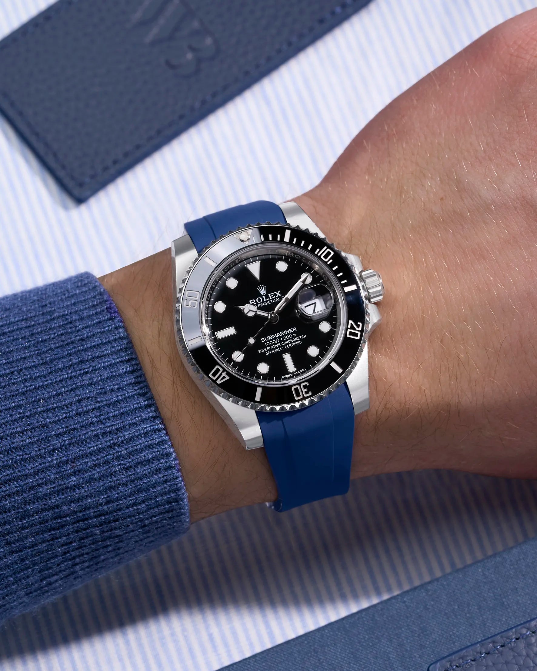 Rolex Submariner 116610LN on wrist with blue rubber strap compatible with original Rolex clasp