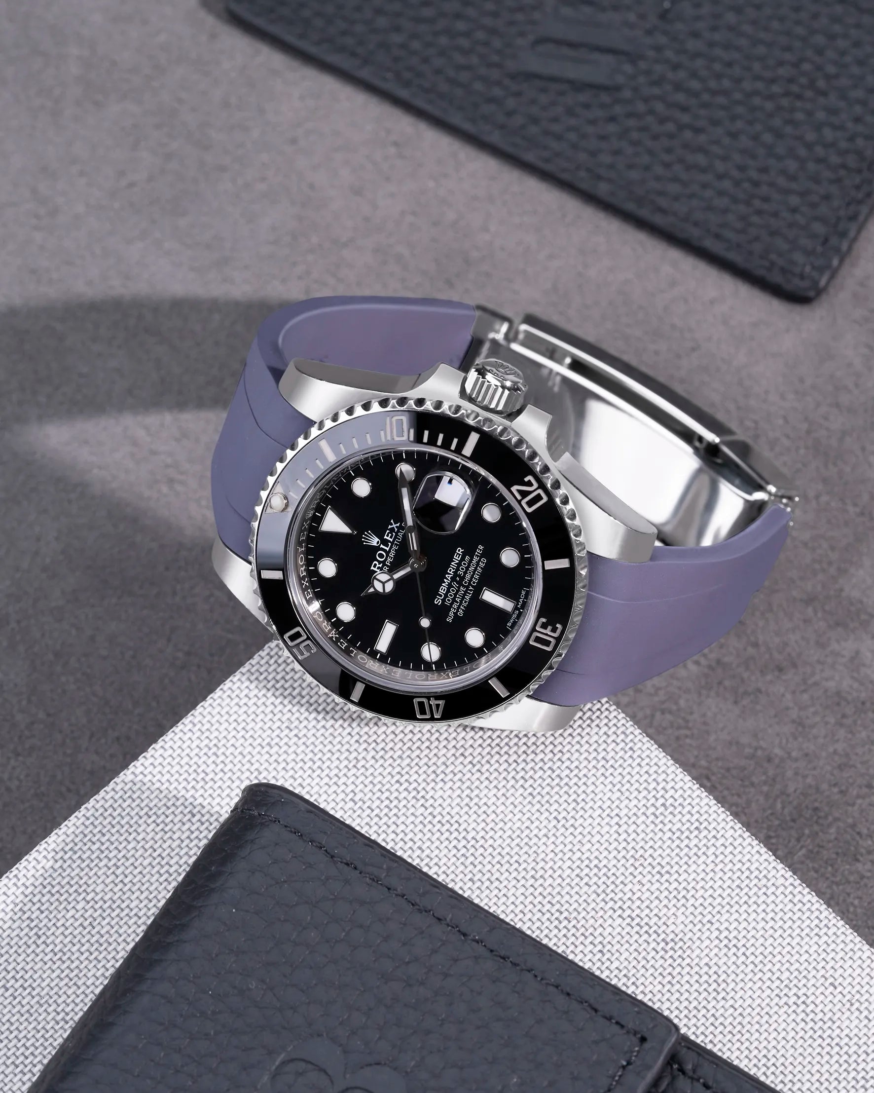 Rolex Submariner 116610LN and 114060LN on grey FKM rubber strap integrated with original Rolex clasp – flatlay presentation
