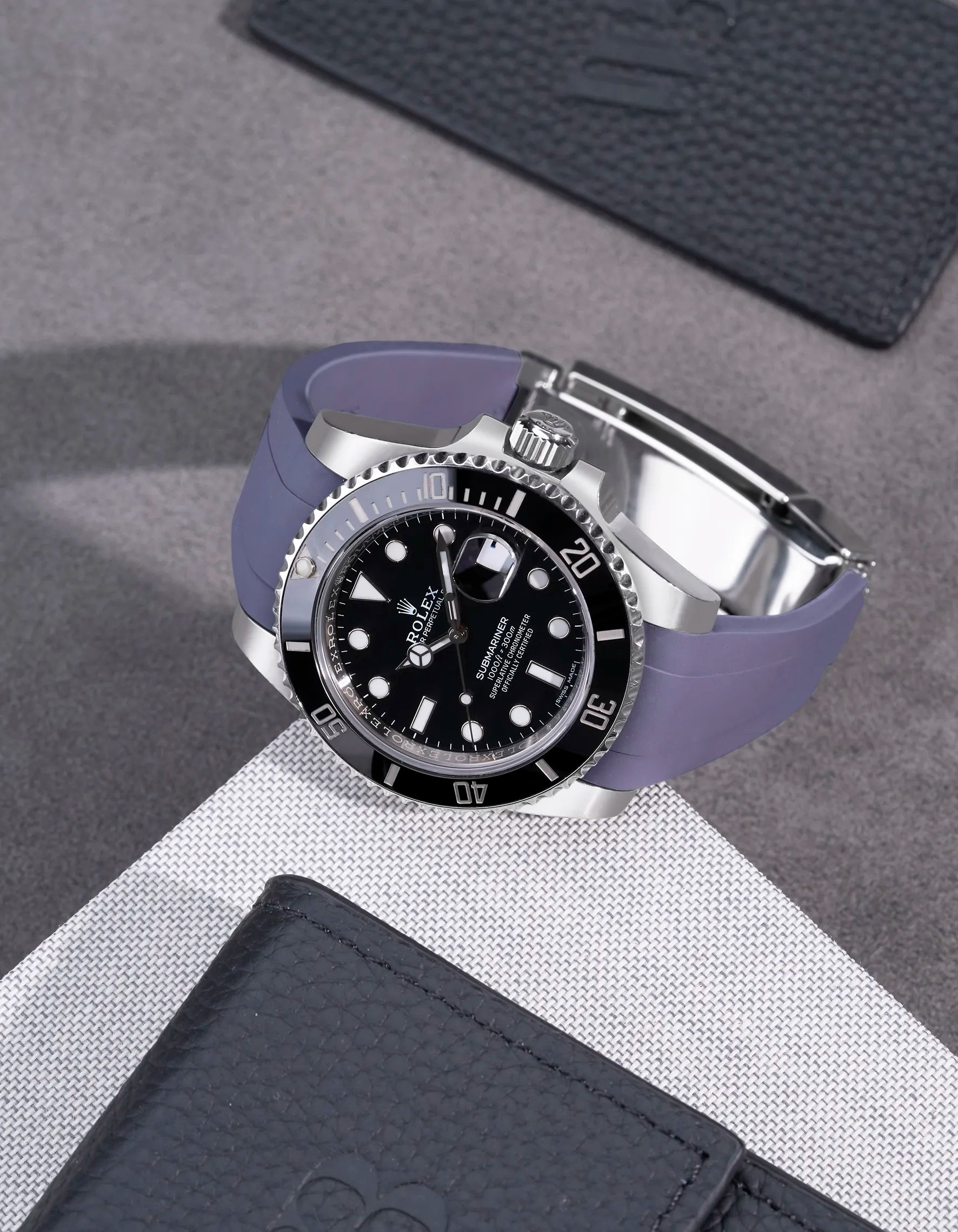 Rolex Submariner 116610LN and 114060LN on grey FKM rubber strap integrated with original Rolex clasp – flatlay presentation