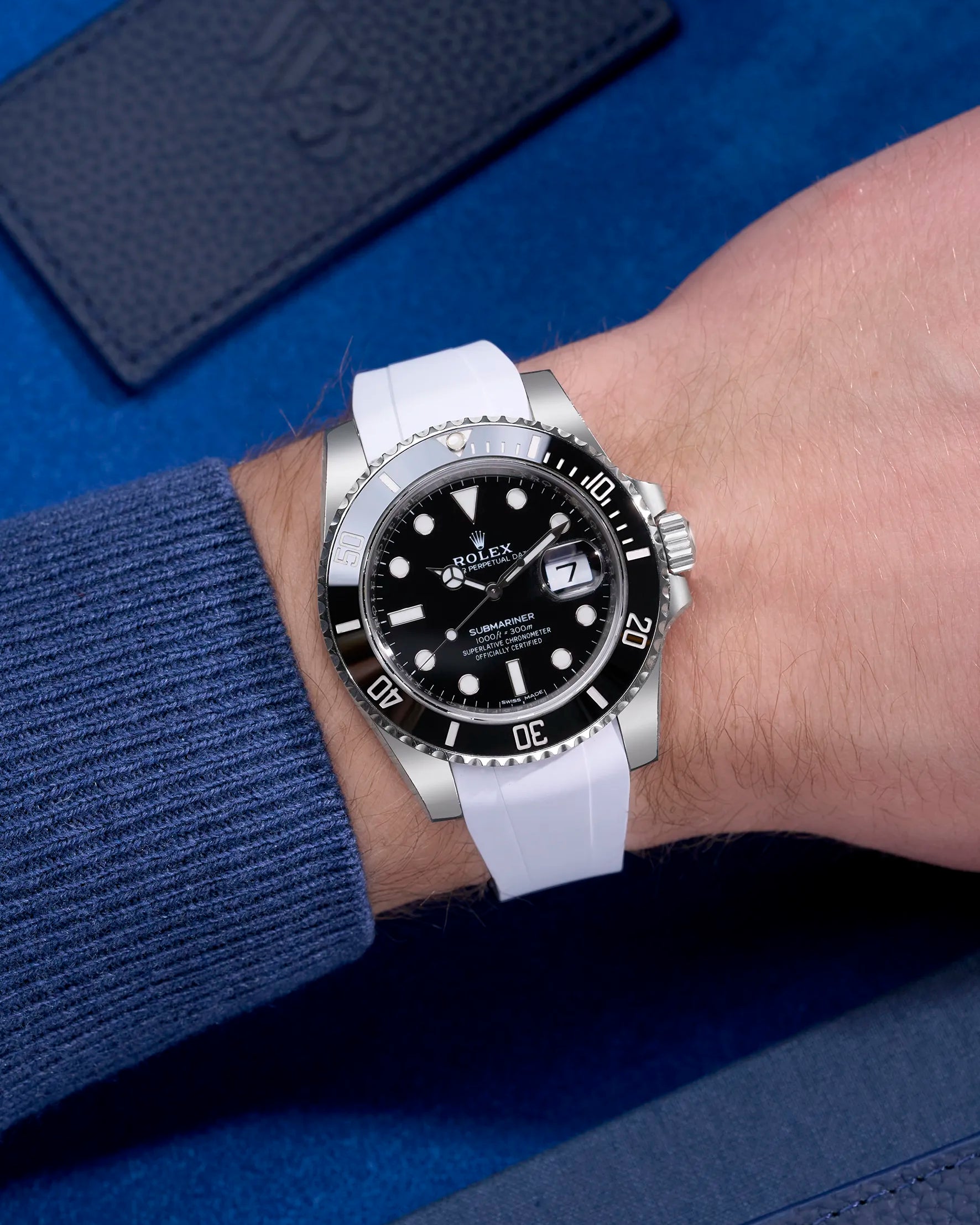 Rolex Submariner 114060LN with integrated white rubber strap and original clasp – wrist shot in natural lighting
