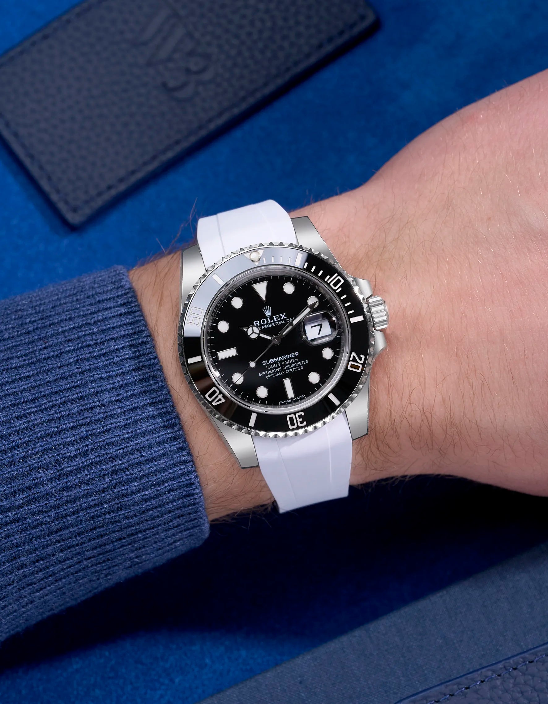 Rolex Submariner 114060LN with integrated white rubber strap and original clasp – wrist shot in natural lighting