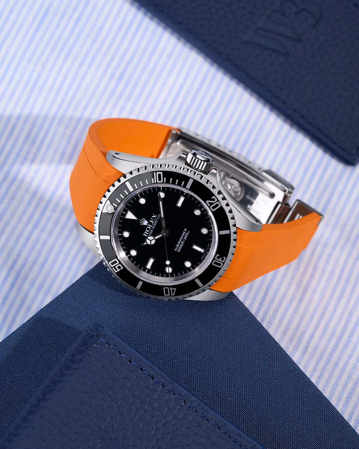 Rolex Submariner 16610/14060 with integrated orange rubber strap and original clasp – flat lay view
