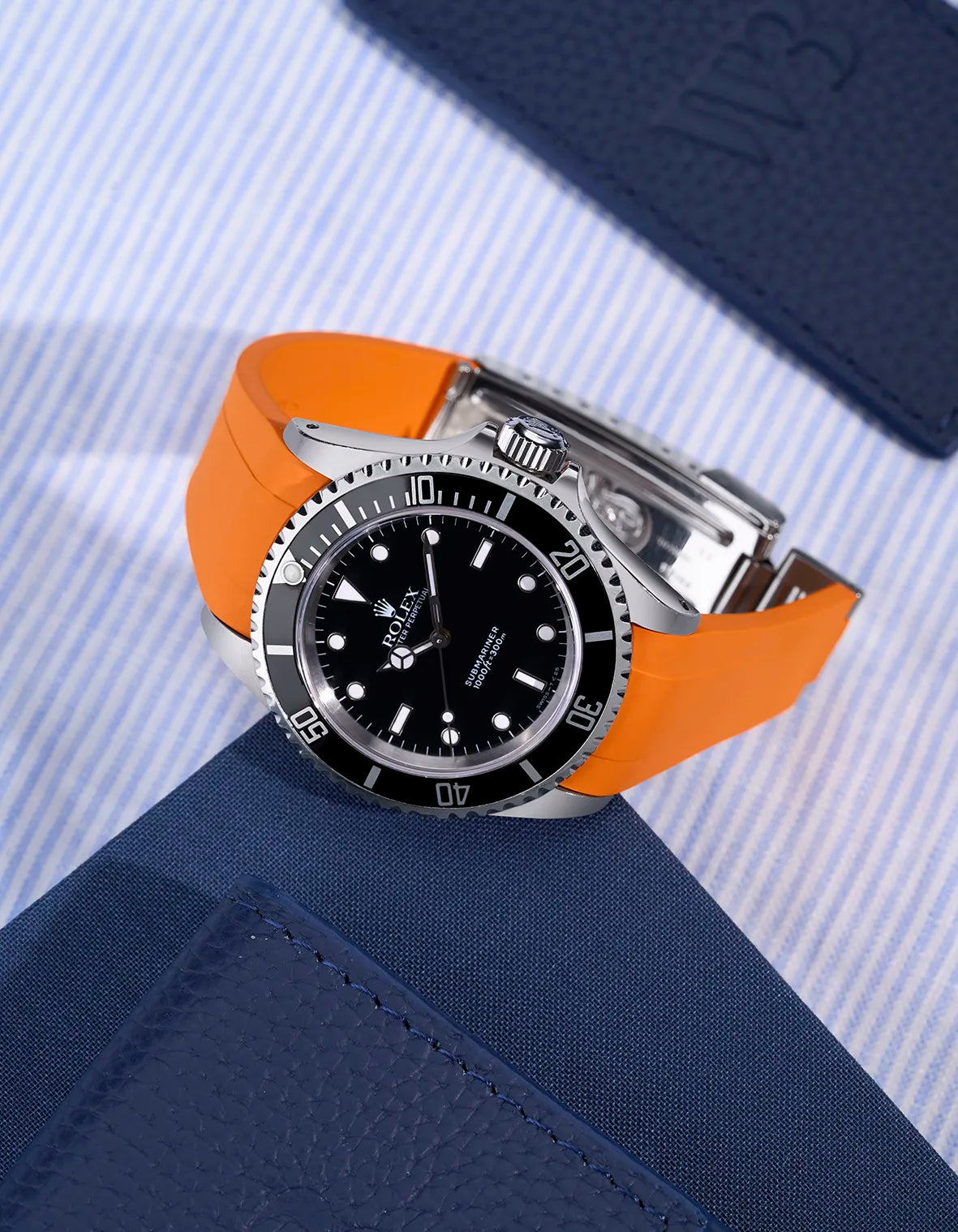 Rolex Submariner 16610/14060 with integrated orange rubber strap and original clasp – flat lay view
