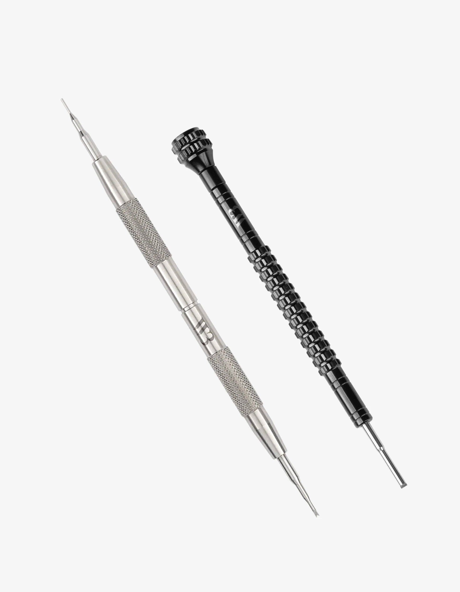 Two precision tools, one metallic and one black with textured grip, on a white background.