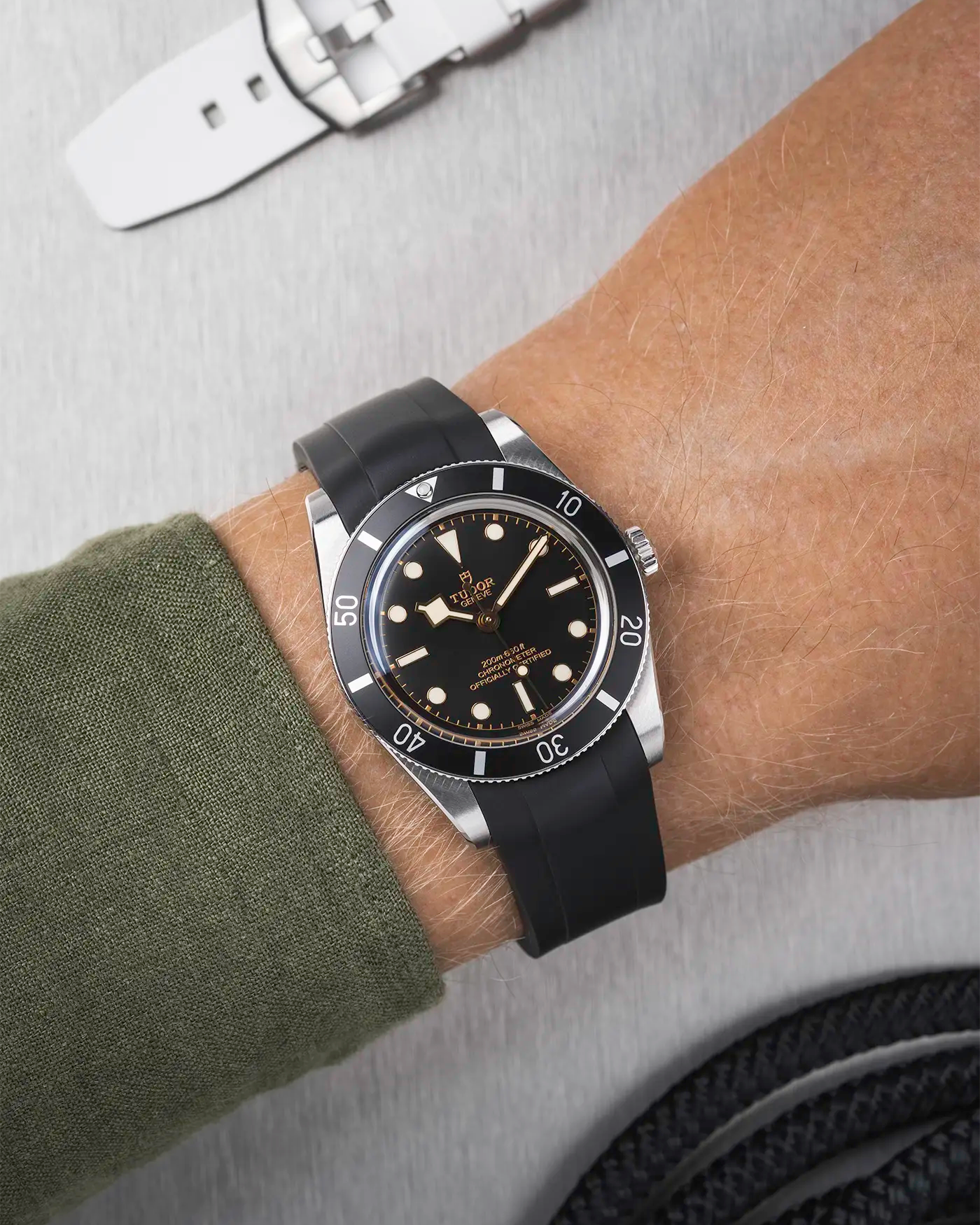 Tudor Black Bay 54 on wrist with black FKM rubber strap and black PVD buckle