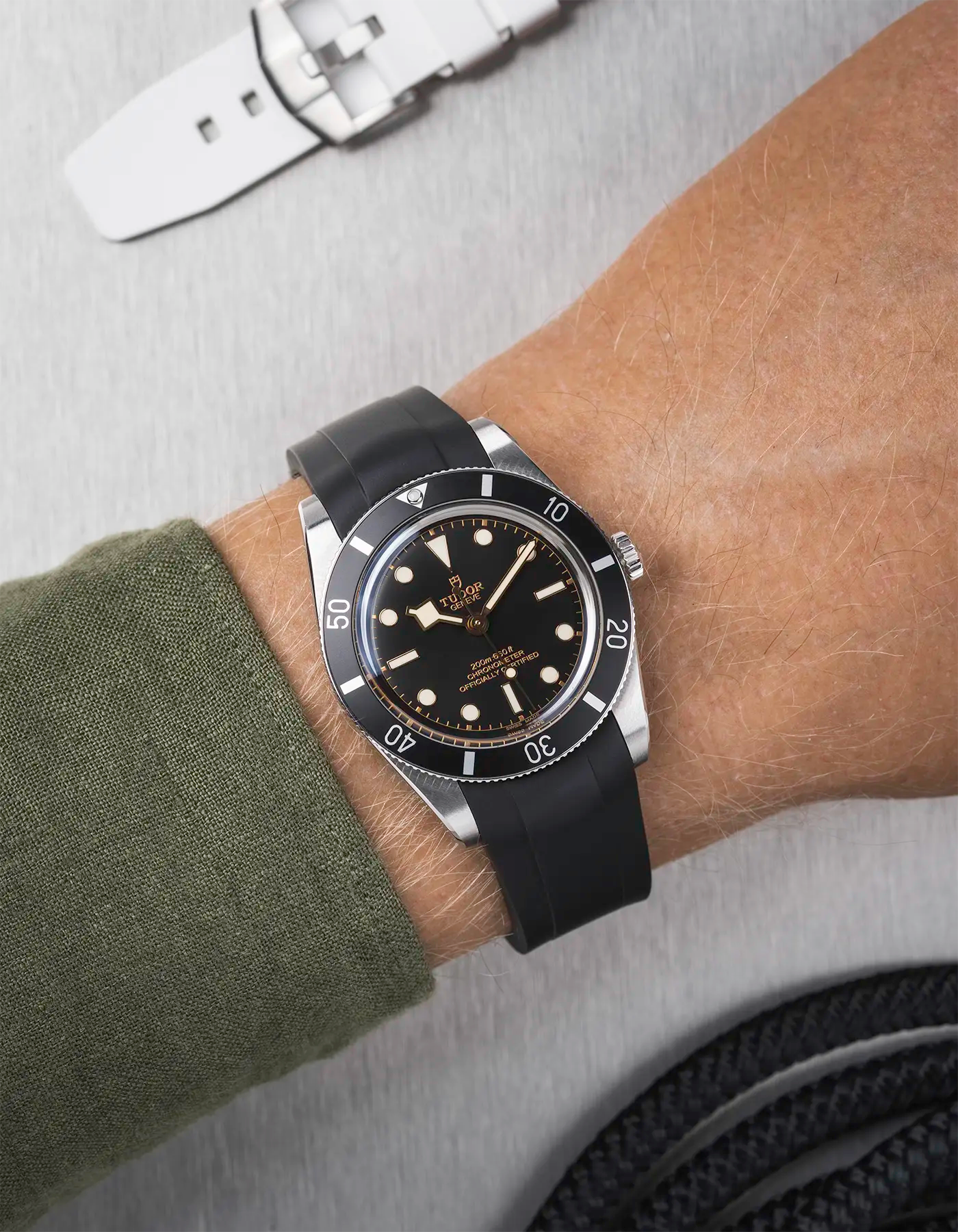 Tudor Black Bay 54 on wrist with black FKM rubber strap and black PVD buckle