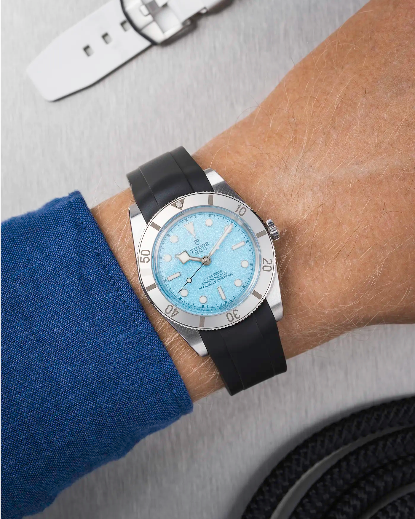 Tudor Black Bay 54 Blue Lagoon on wrist with black FKM rubber strap and black PVD buckle