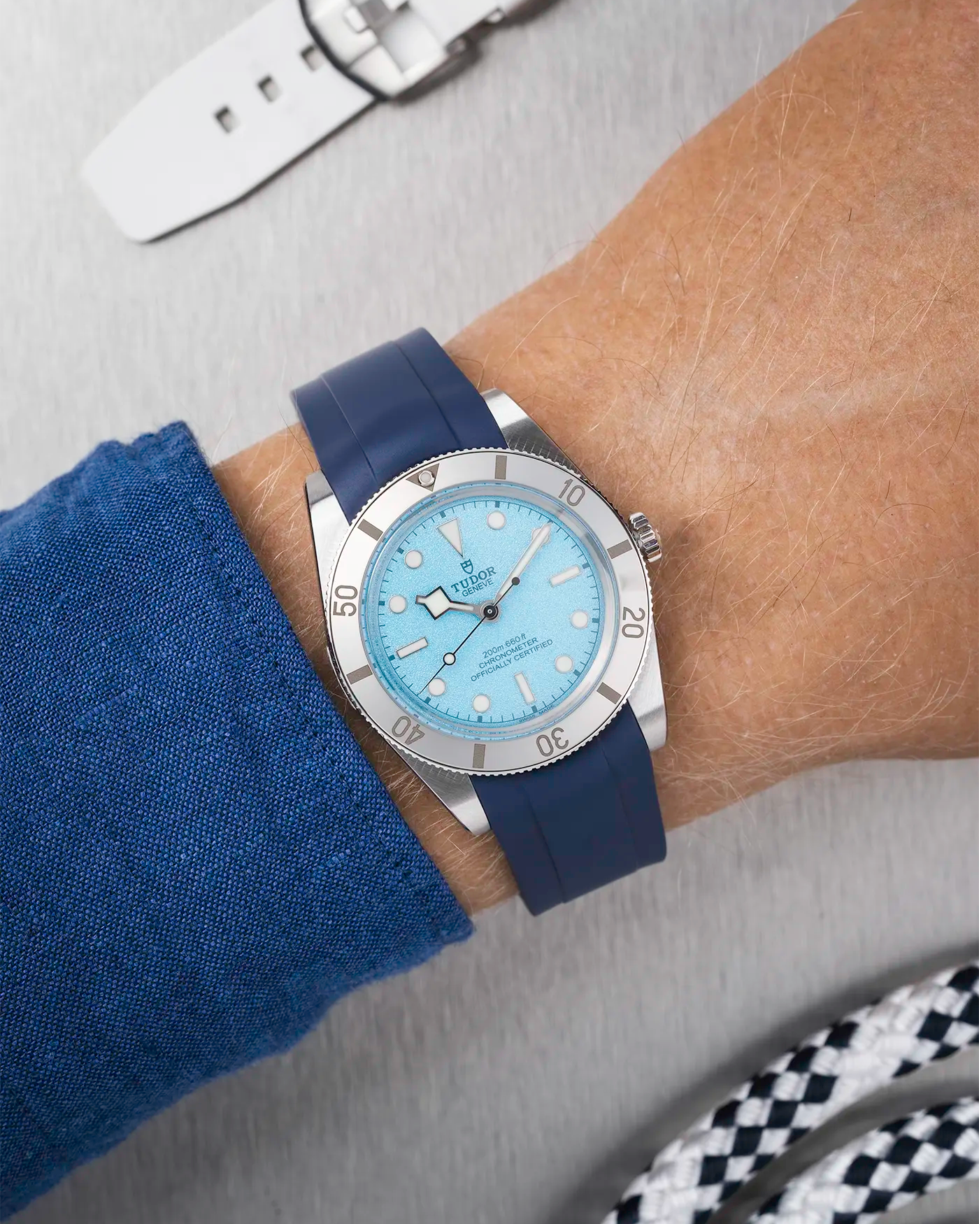 Tudor Black Bay 54 Blue Lagoon on wrist with navy blue FKM rubber strap and stainless steel buckle