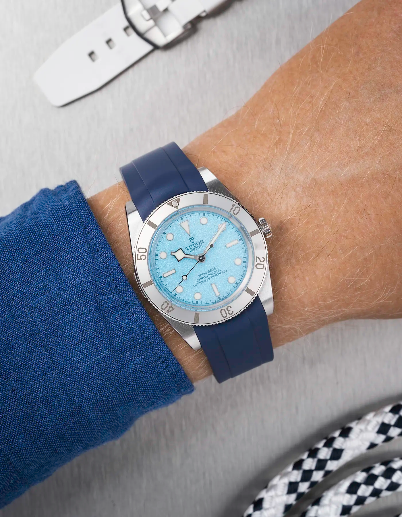 Tudor Black Bay 54 Blue Lagoon on wrist with navy blue FKM rubber strap and stainless steel buckle