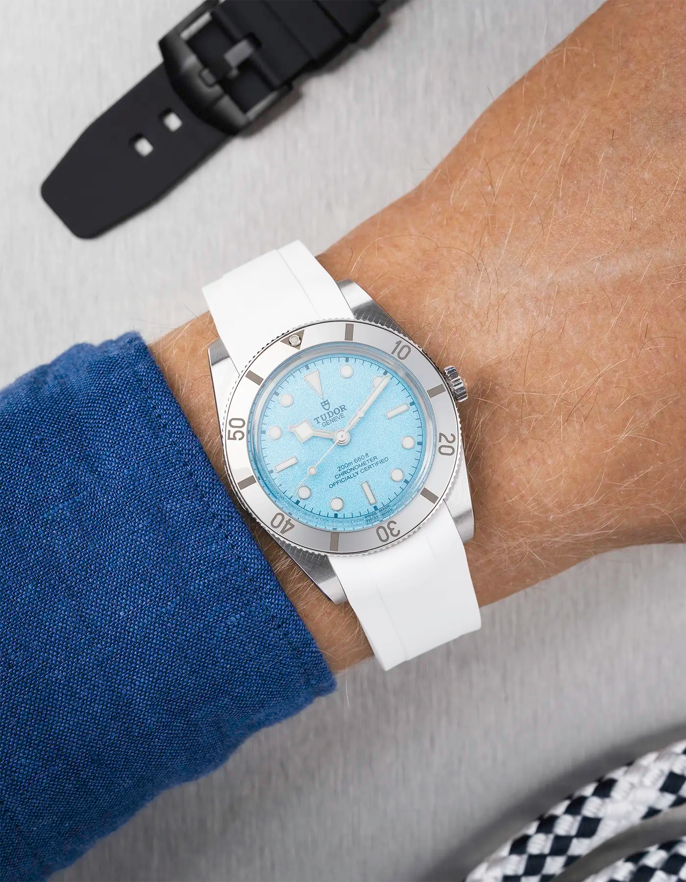 Tudor Black Bay 54 Blue Lagoon on wrist with white FKM rubber strap and stainless steel buckle