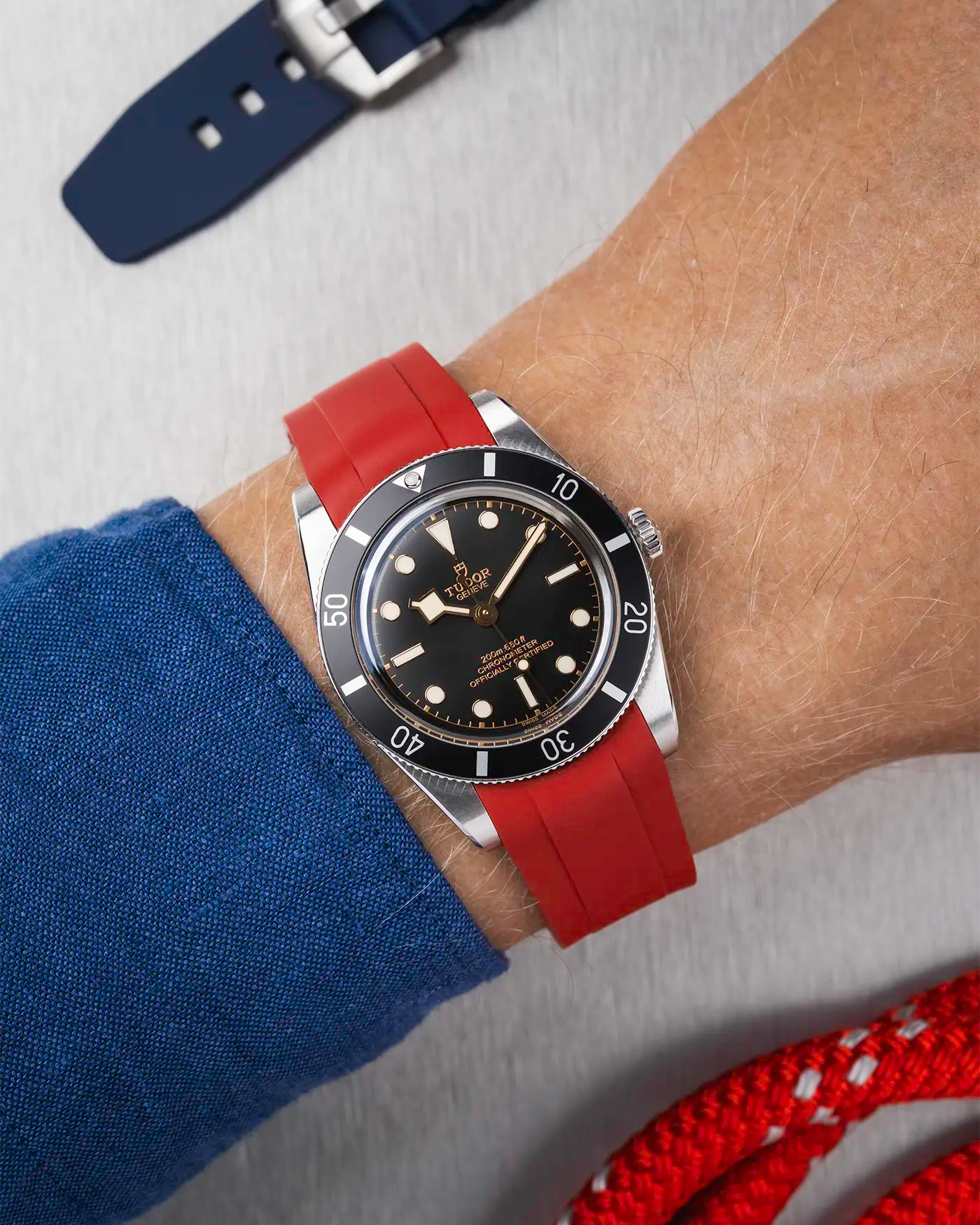 Tudor Black Bay 54 on wrist with burgundy red FKM rubber strap and stainless steel buckle