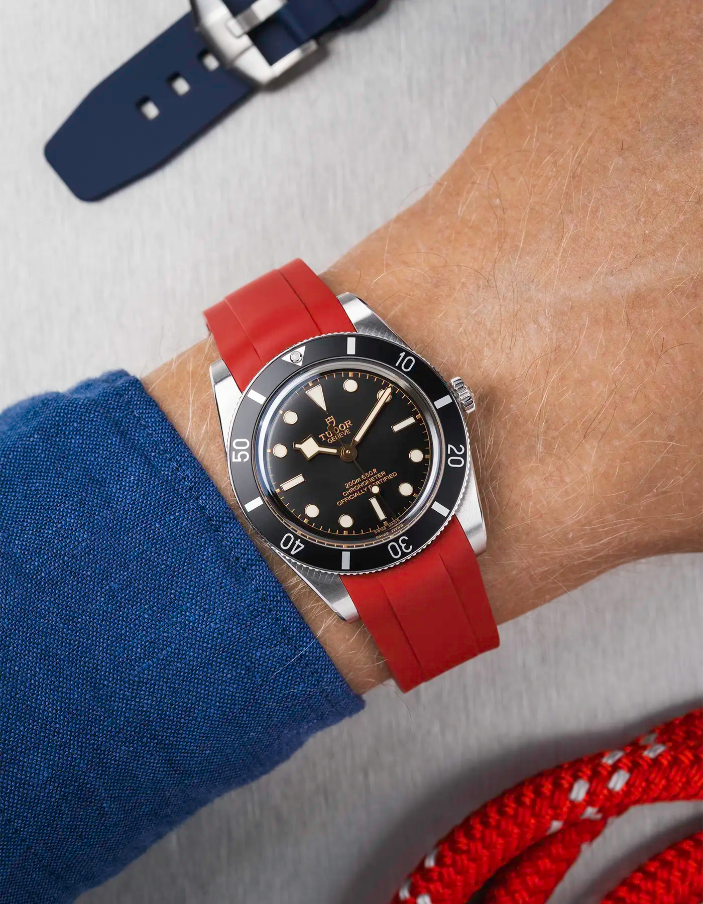 Tudor Black Bay 54 on wrist with burgundy red FKM rubber strap and stainless steel buckle
