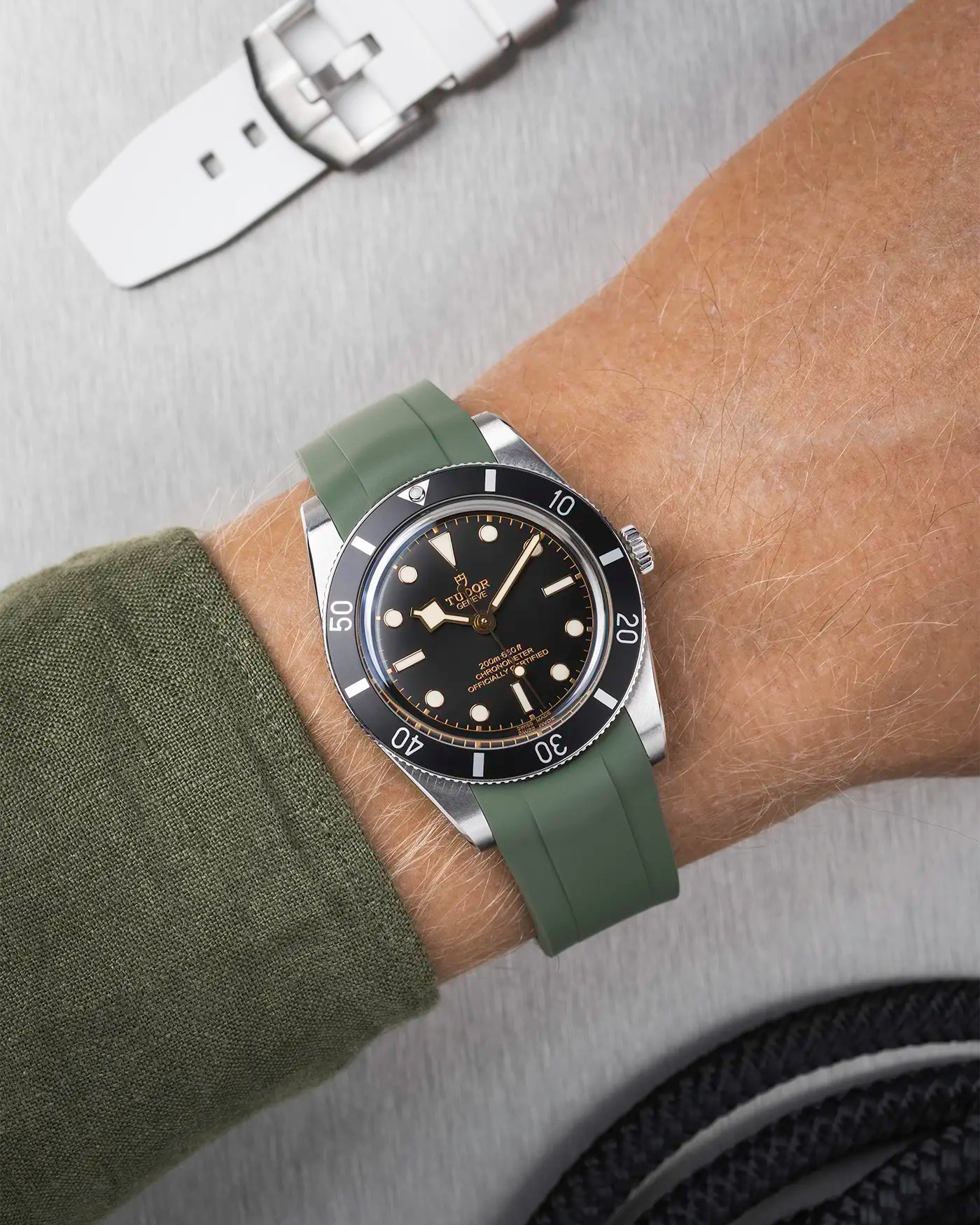 Tudor Black Bay 54 on wrist with dark green FKM rubber strap and stainless steel buckle