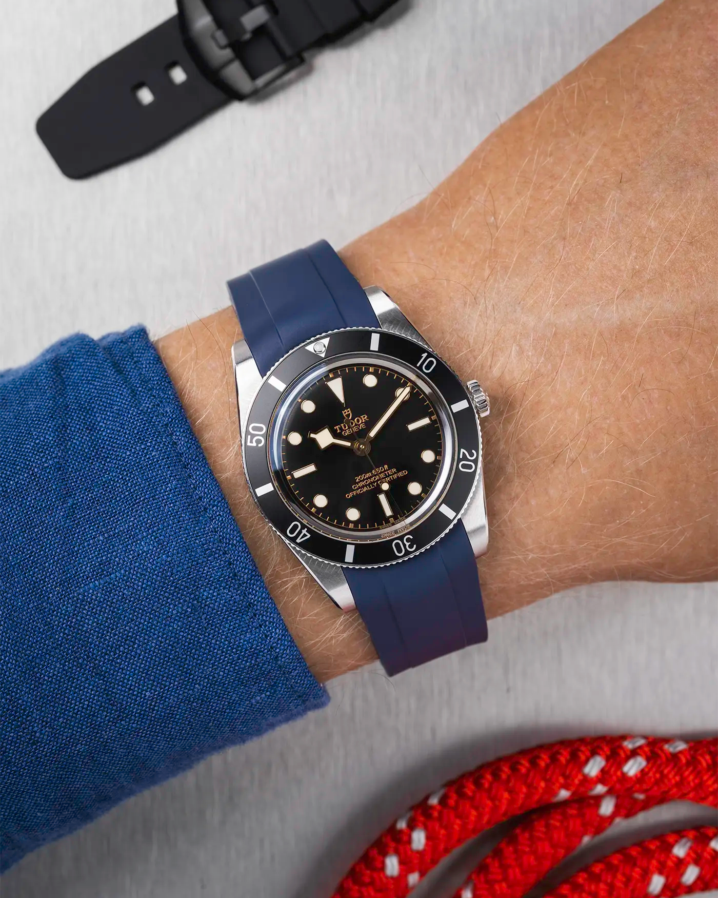 Tudor Black Bay 54 on wrist with navy blue FKM rubber strap and stainless steel buckle