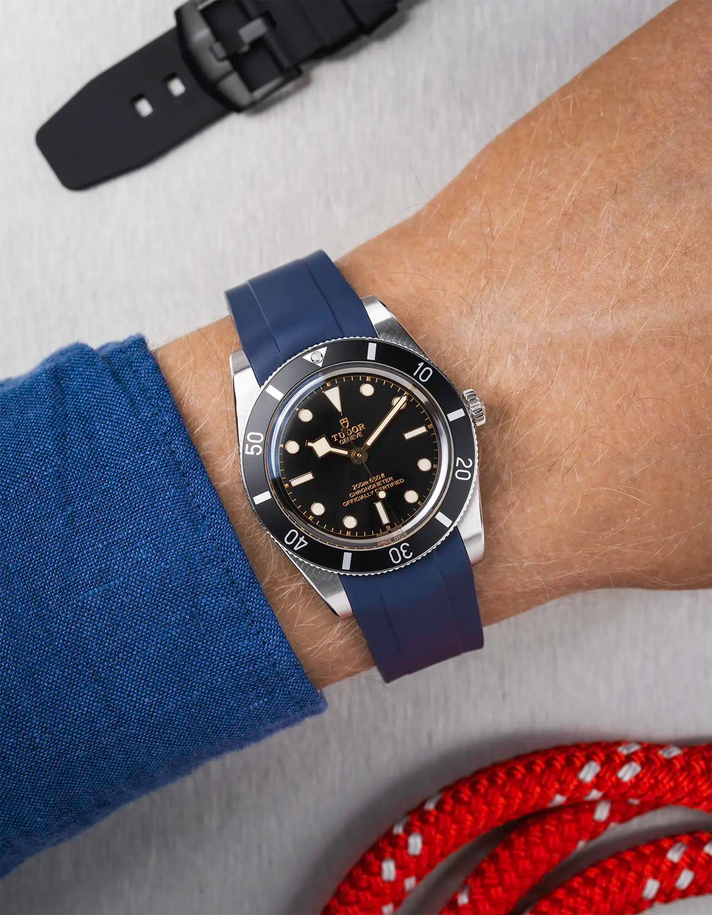 Tudor Black Bay 54 on wrist with navy blue FKM rubber strap and stainless steel buckle