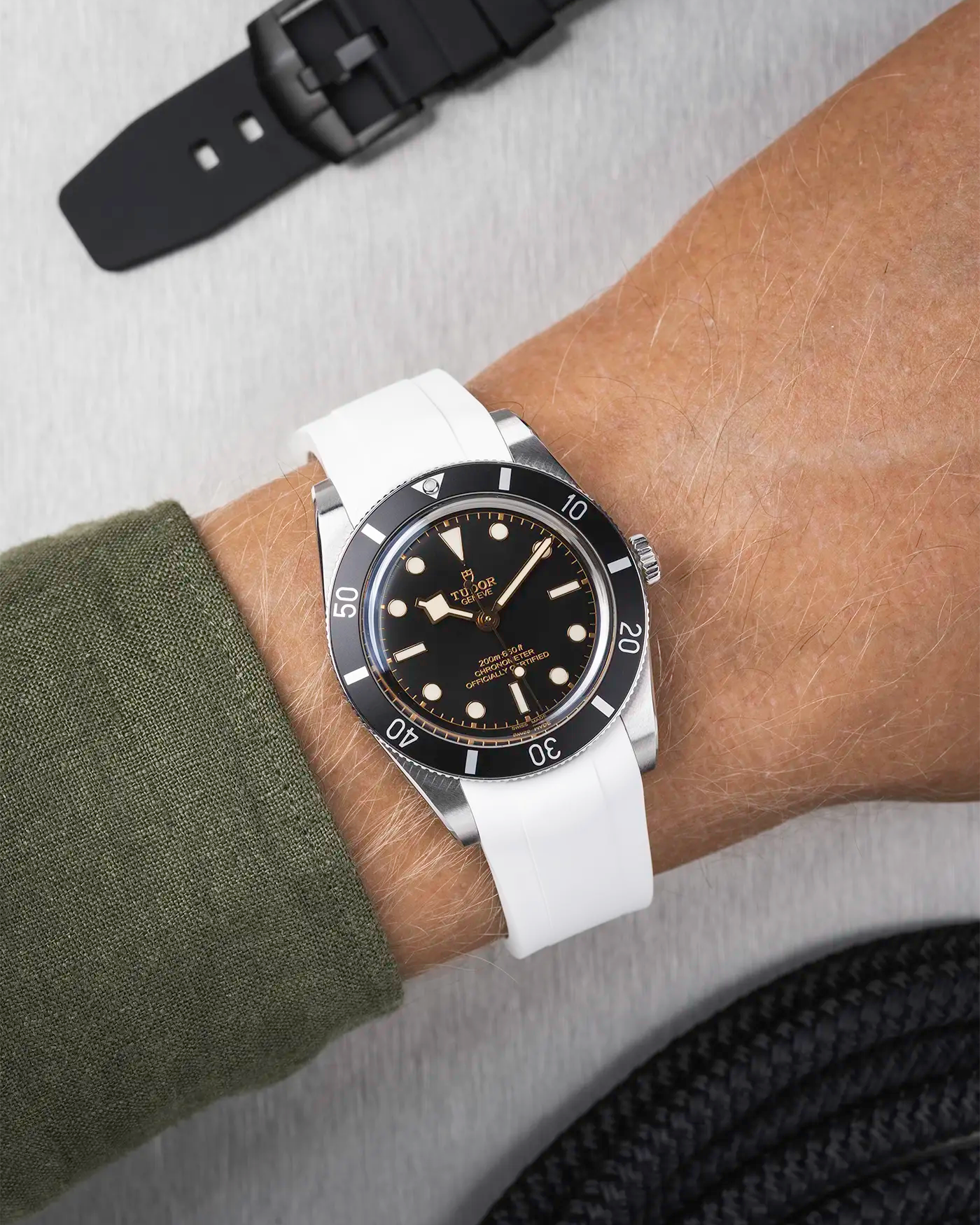 Tudor Black Bay 54 on wrist with white FKM rubber strap and stainless steel buckle