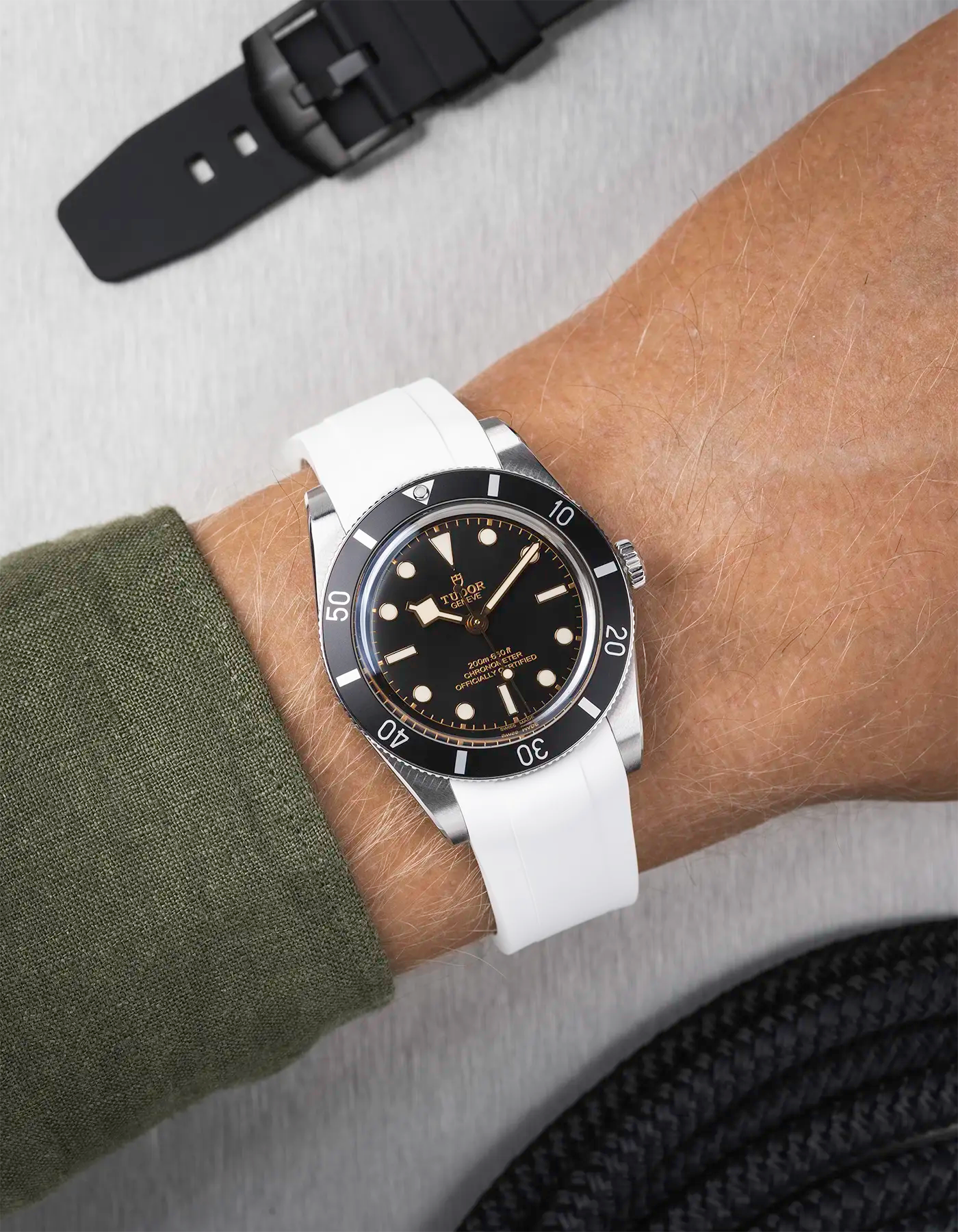 Tudor Black Bay 54 on wrist with white FKM rubber strap and stainless steel buckle