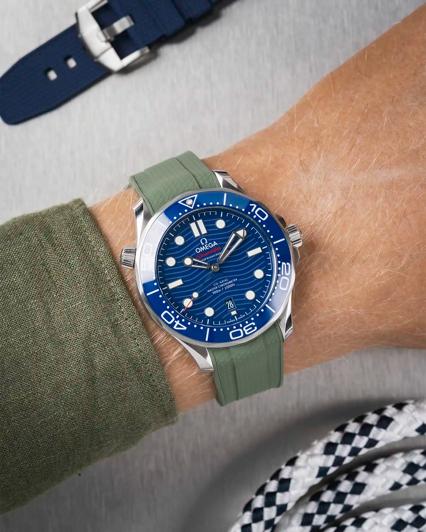 Omega Seamaster 300 Diver with blue dial on wrist, paired with dark green Vertech FKM rubber strap