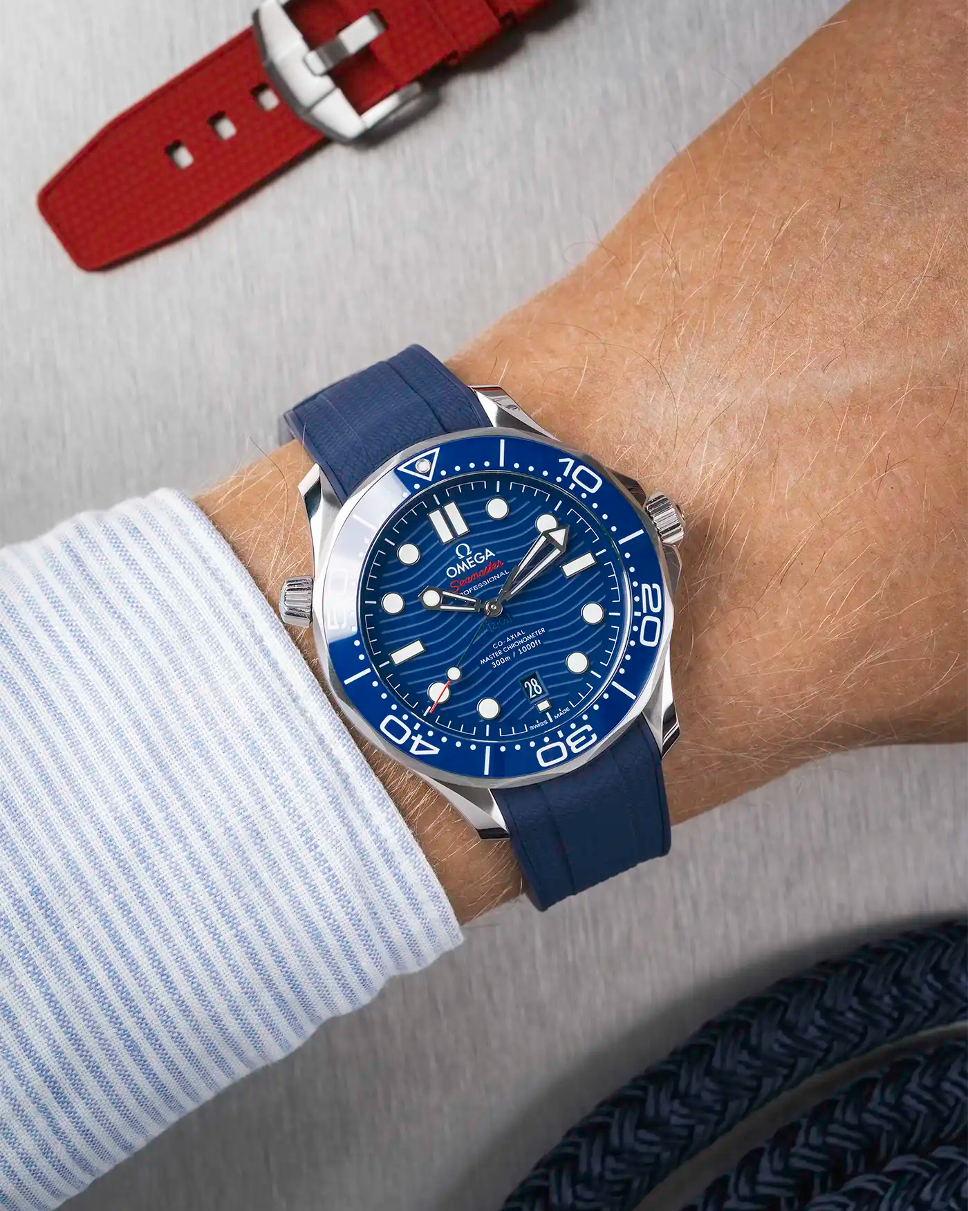 Omega Seamaster 300 Diver with blue dial on wrist, paired with navy blue Vertech FKM rubber strap