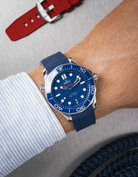 Omega Seamaster 300 Diver with blue dial on wrist, paired with navy blue Vertech FKM rubber strap