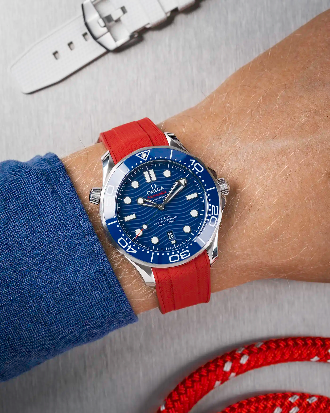 Omega Seamaster 300 Diver with blue dial on wrist, paired with red Vertech FKM rubber strap