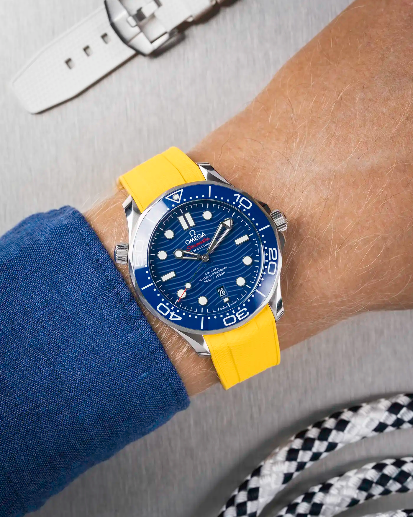 Omega Seamaster 300 Diver with blue dial on wrist, paired with yellow Vertech FKM rubber strap