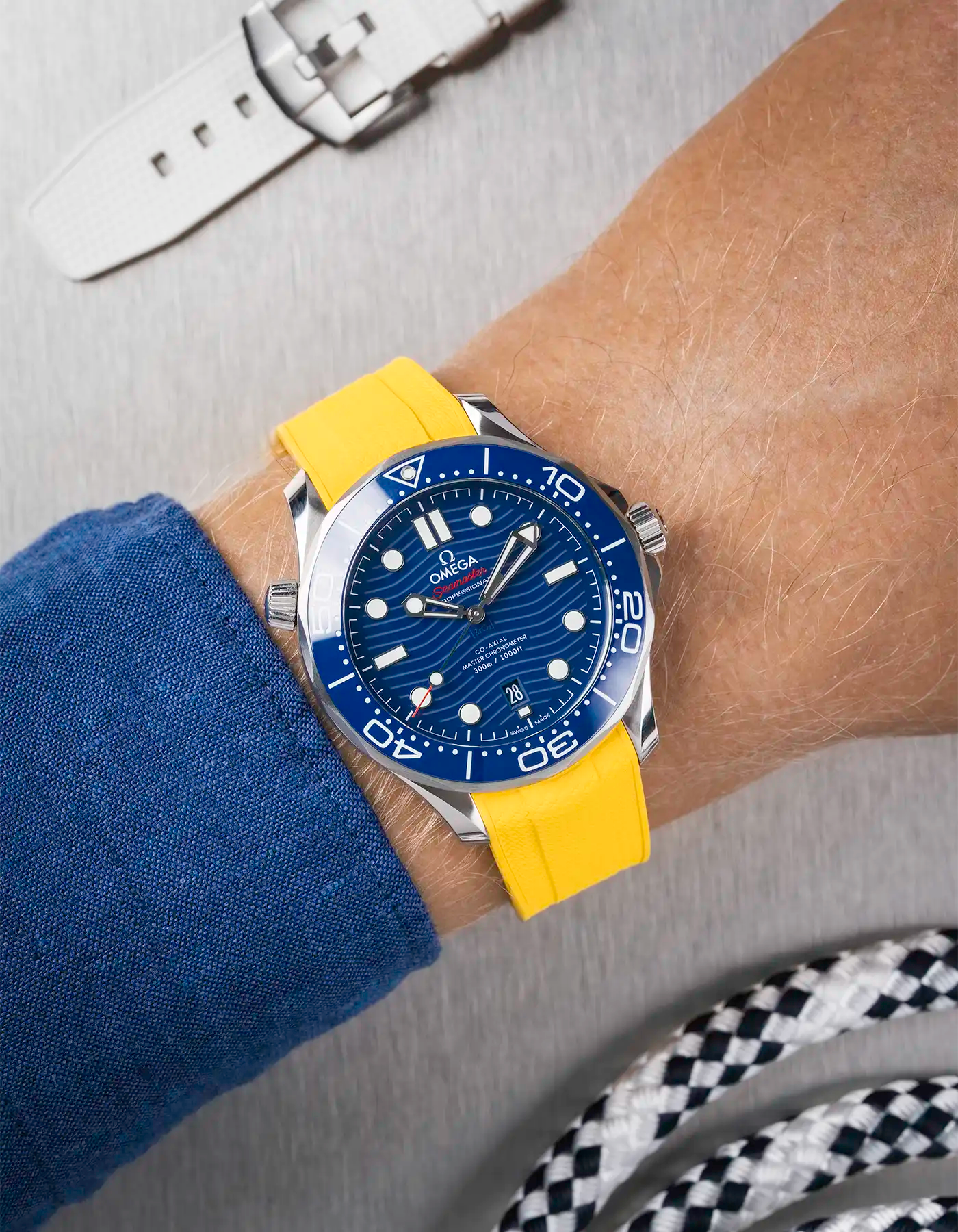 Omega Seamaster 300 Diver with blue dial on wrist, paired with yellow Vertech FKM rubber strap