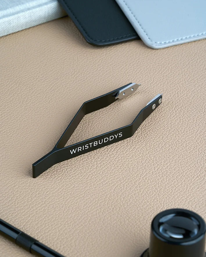 Wristbuddys Spring Bar Tweezer placed on desk – premium strap-changing tool for watches