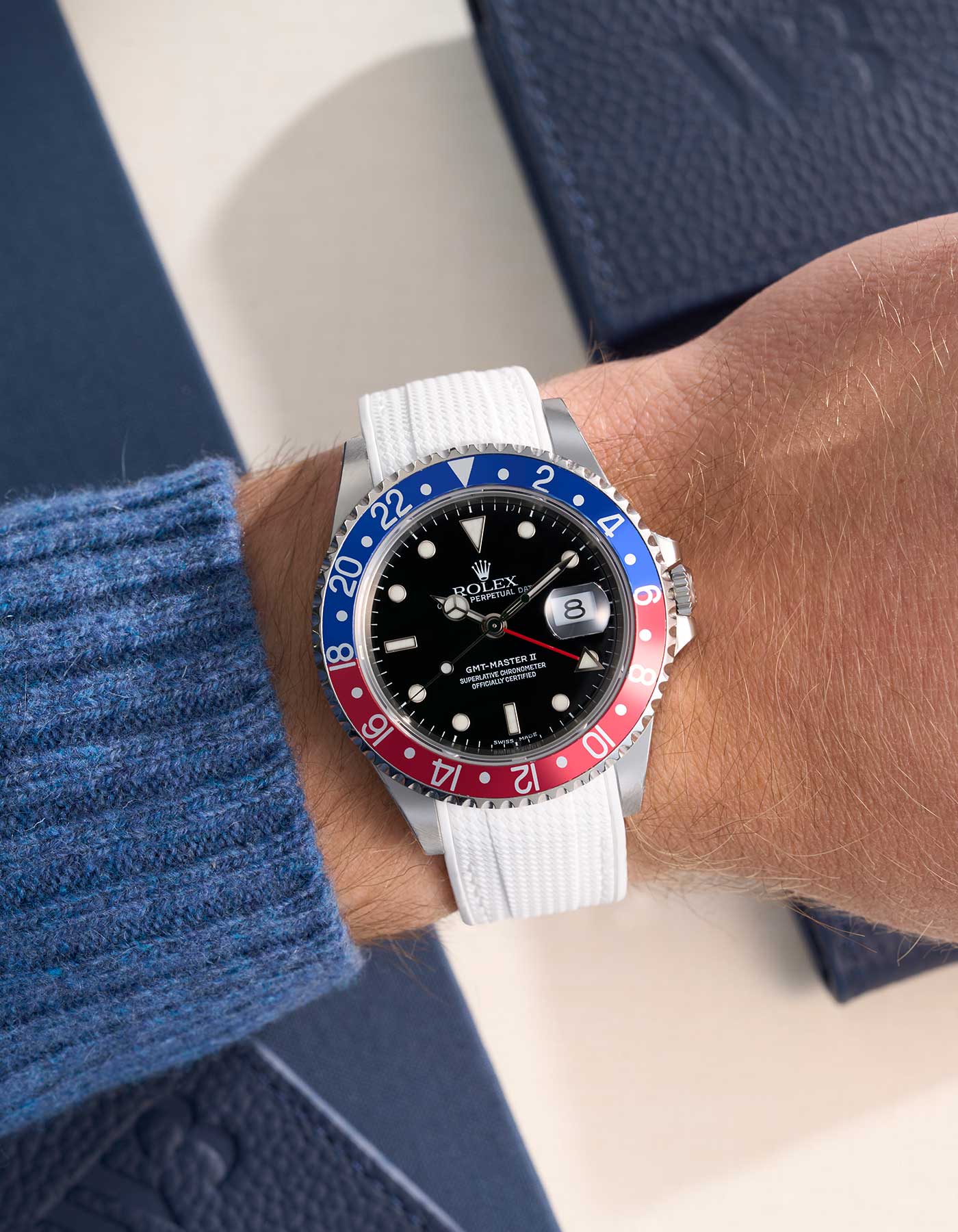 Rolex GMT-Master II with a white premium rubber strap, shown on a wrist for a modern and exclusive look.