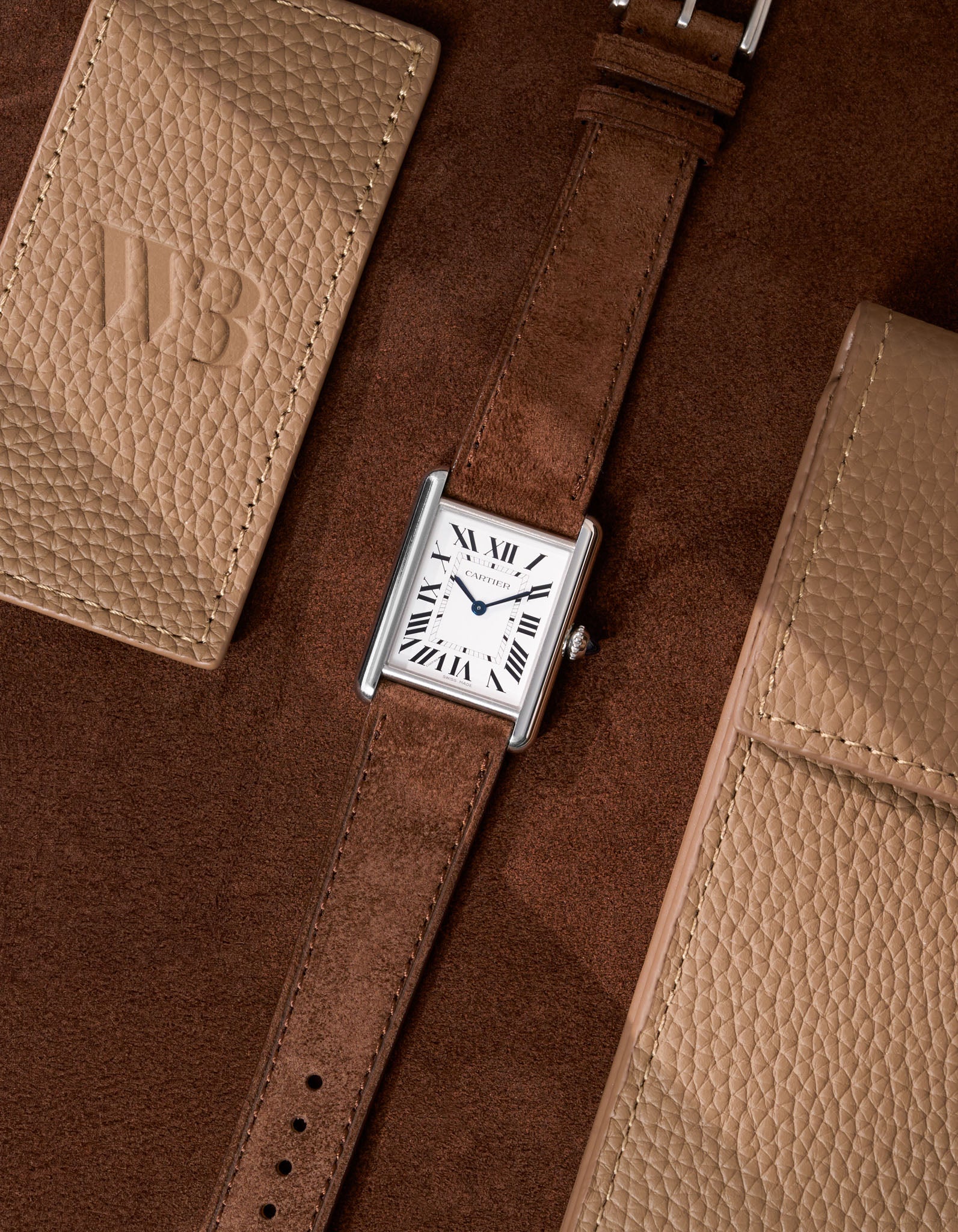 Cartier Tank Must Large featuring brown Suede leather strap, watch facing up on table surface