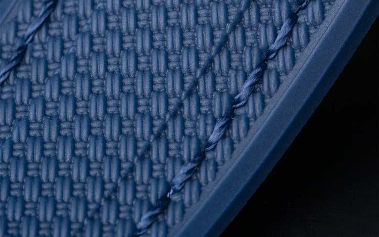 Close-up of blue Vertech rubber strap with embossed textured pattern and matching stitching