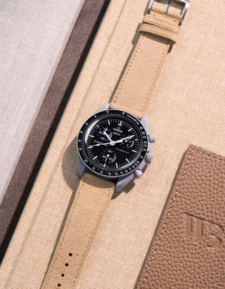 Flat lay Moonswatch Mission to the Moon with Beige suede leather strap