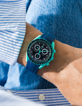 Blue rubber strap for OMEGA x Swatch MoonSwatch Mission On Earth – Polar Lights, worn on the wrist in a lifestyle shot with clothing visible