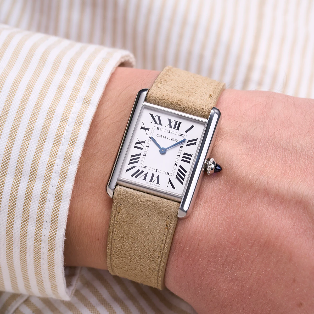 Cartier Tank watch with a beige suede leather strap from Wristbuddys, worn on a wrist, showcasing an elegant and timeless design. Ideal for anyone looking to upgrade their watch with premium Cartier leather straps for style and comfort.