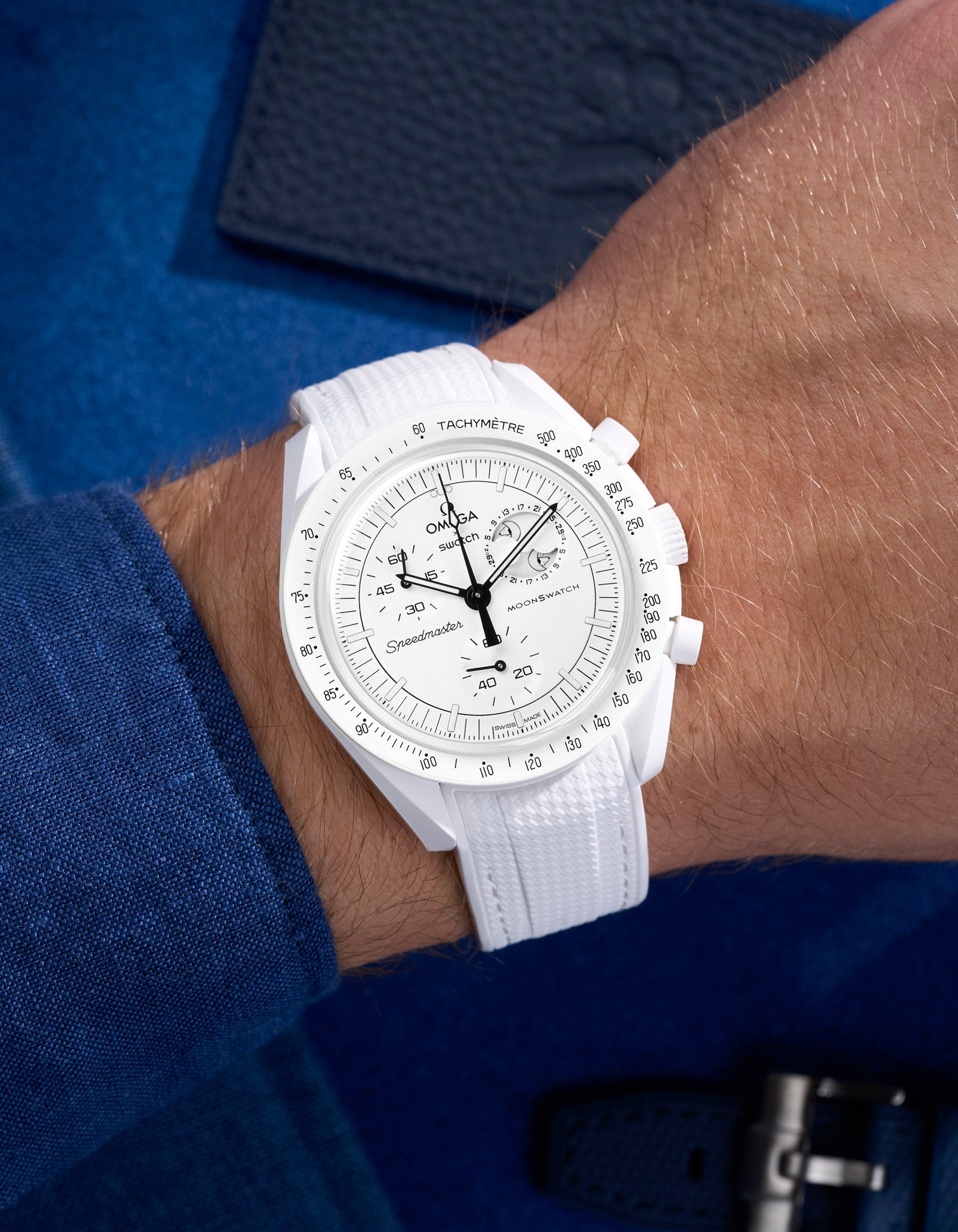 White Vertech rubber strap on Omega Swatch MoonSwatch Mission to the Moonphase shown on wrist with shirt