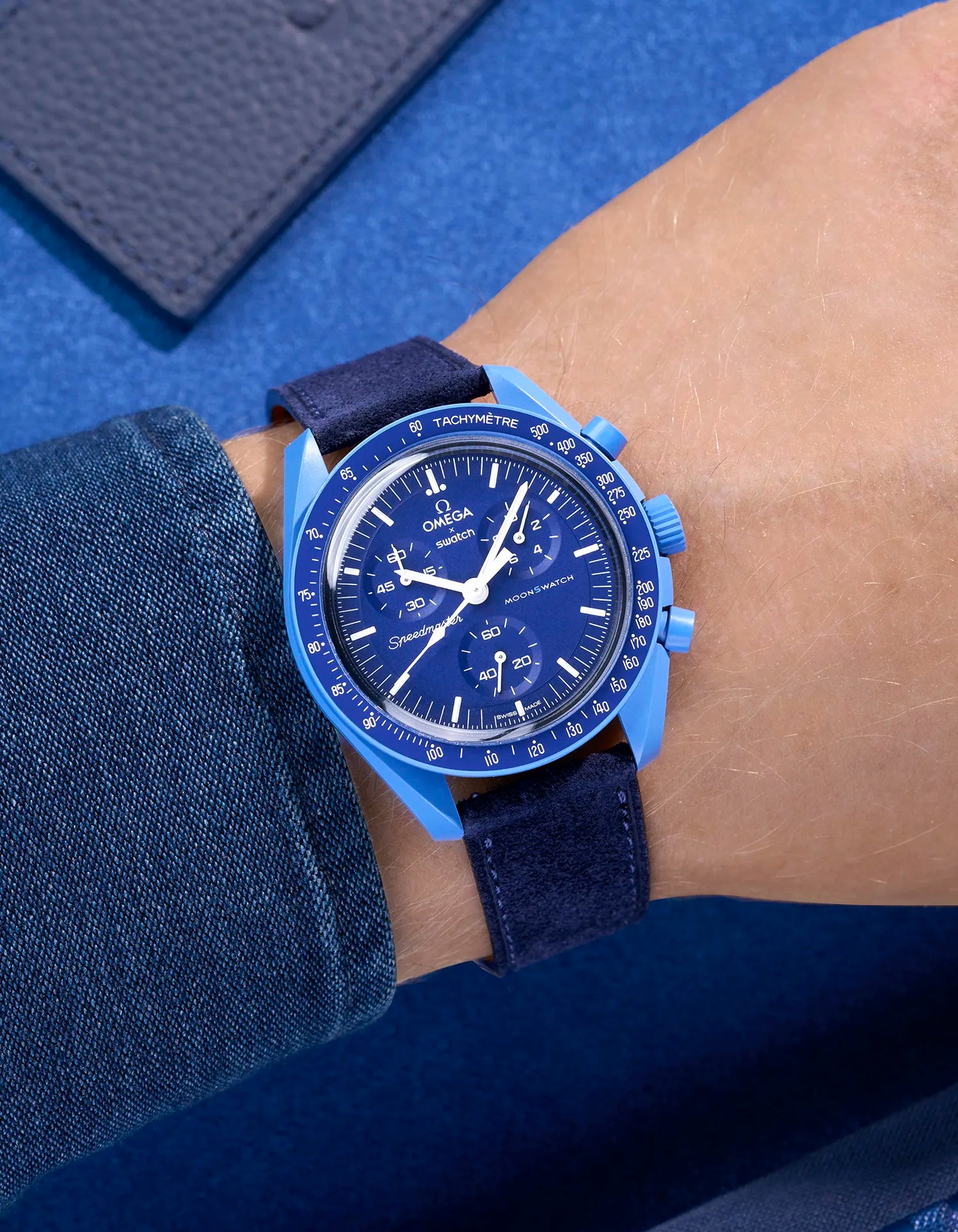 Omega X Swatch Mission to Neptune with Dark Blue suede leather strap worn on wrist