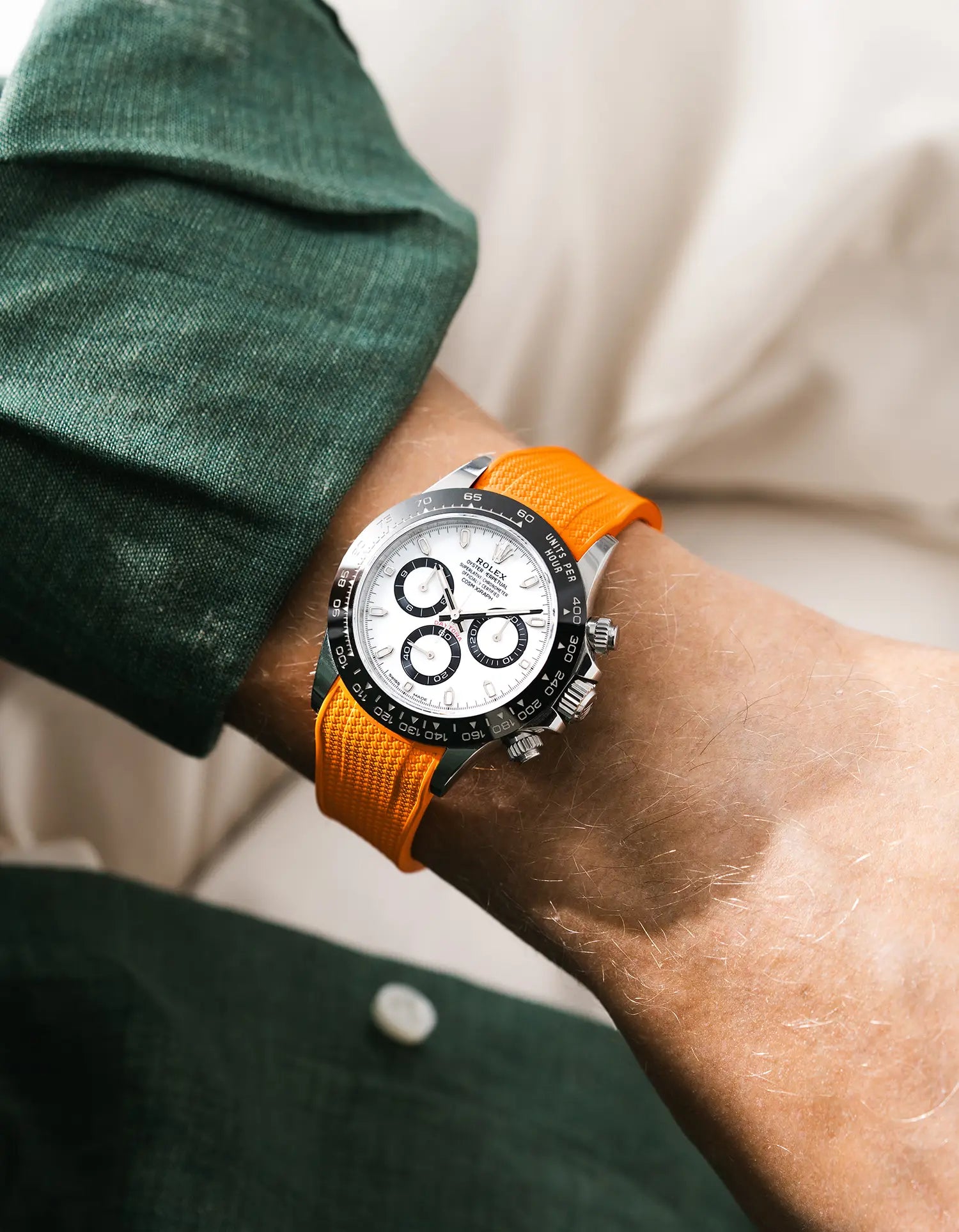 Vertech orange integrated FKM rubber strap with original clasp on Rolex Daytona 116500 white dial ceramic bezel wrist shot green shirt