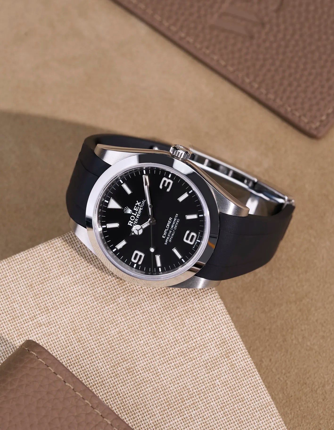 Rolex Explorer 214270 on integrated black FKM rubber strap with original clasp – flat lay view