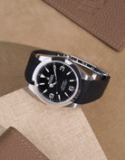 Rolex Explorer 214270 on integrated black FKM rubber strap with original clasp – flat lay view