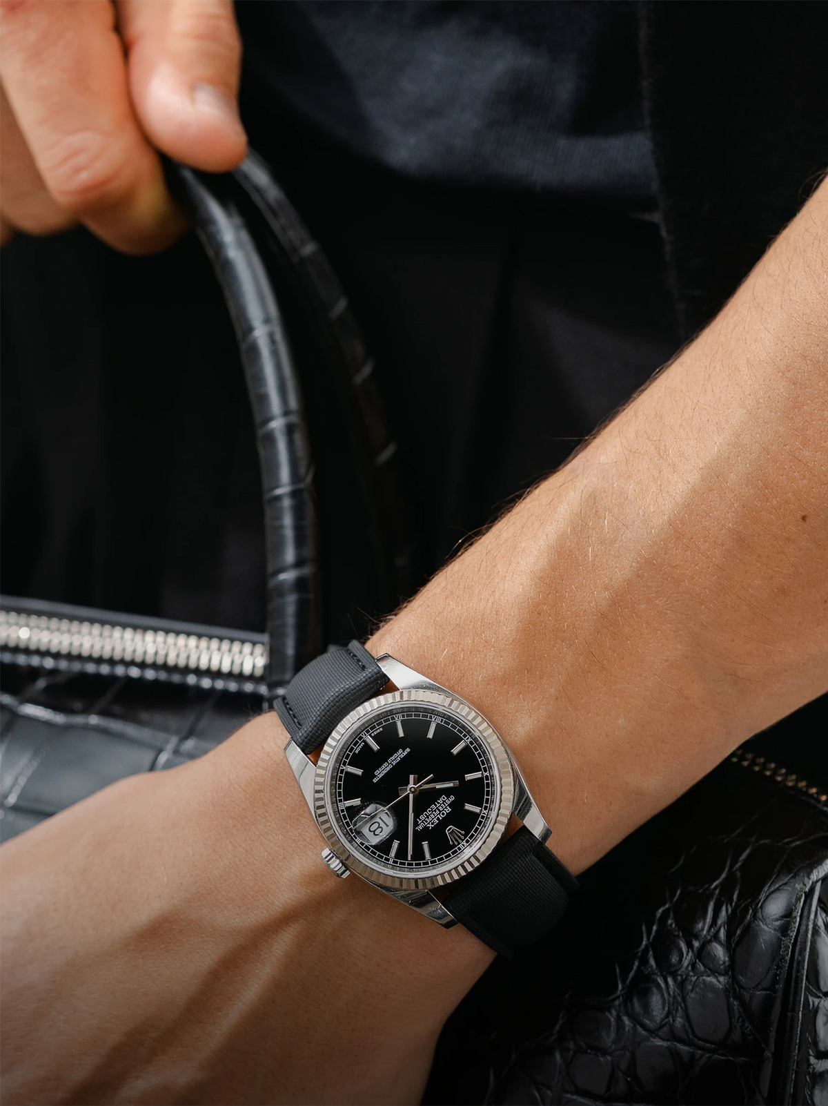 Black watch strap with black bag and background 