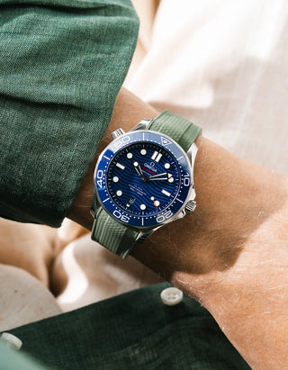Green Vertech rubber strap for Omega Seamaster Diver 300 42mm – worn on wrist with green linen jacket, blue dial and bezel