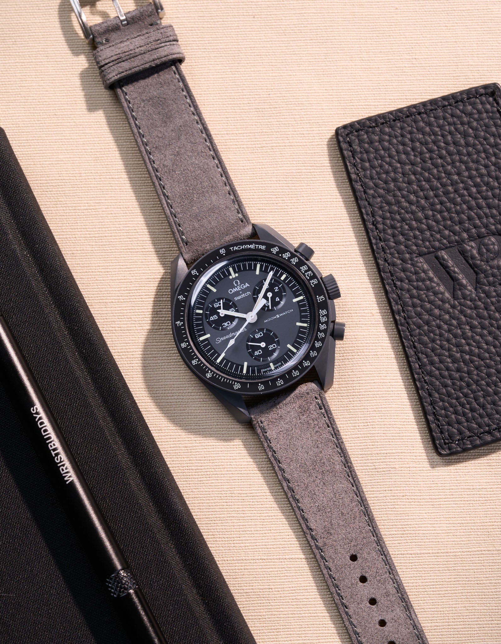 Flat lay Moonswatch Mission to Mercury with Grey suede leather strap