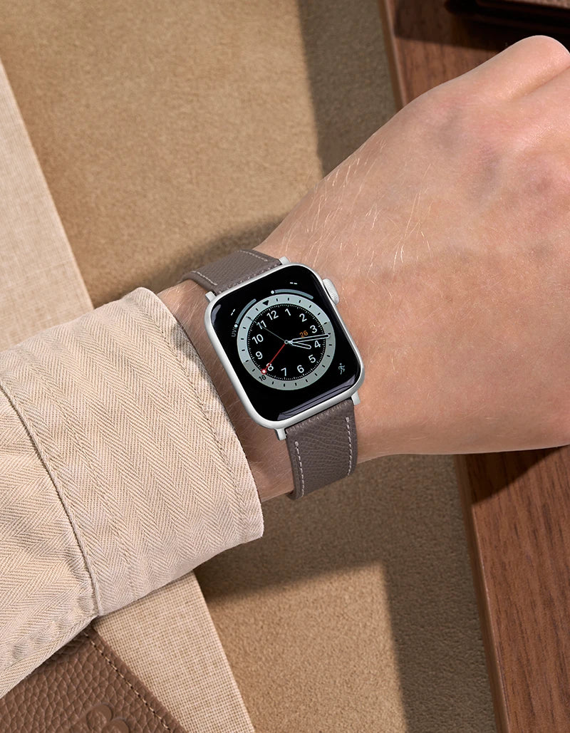 Grey Epsom Leather Apple Watch Band on wrist with beige background