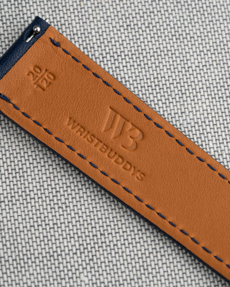 Close-up of the inside of a Wristbuddys leather watch strap, highlighting the embossed logo, fine stitching, and premium craftsmanship.