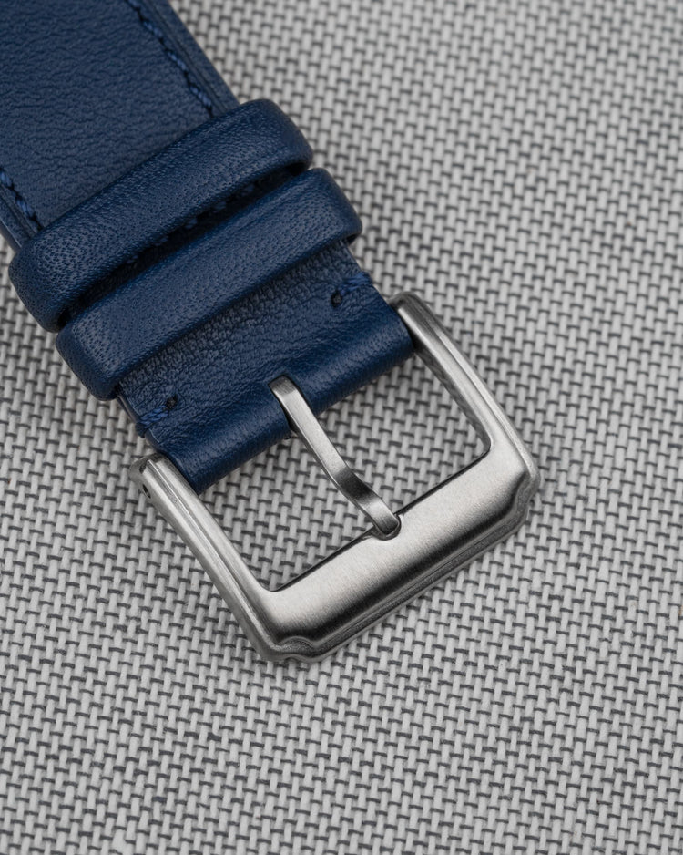 Close-up of the leather buckle on a navy blue Wristbuddys leather strap, highlighting premium craftsmanship and attention to detail.
