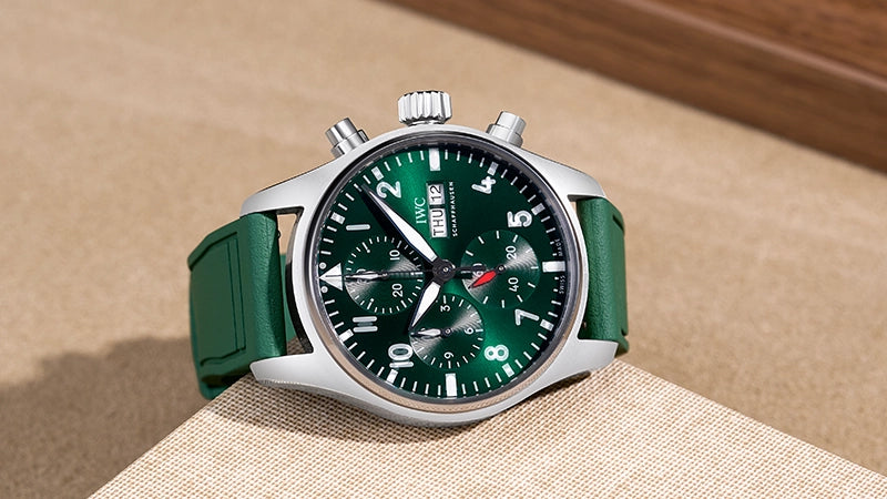 Green rubber strap for IWC Pilot Chronograph, designed for a perfect fit. Premium replacement strap displayed on a beige surface